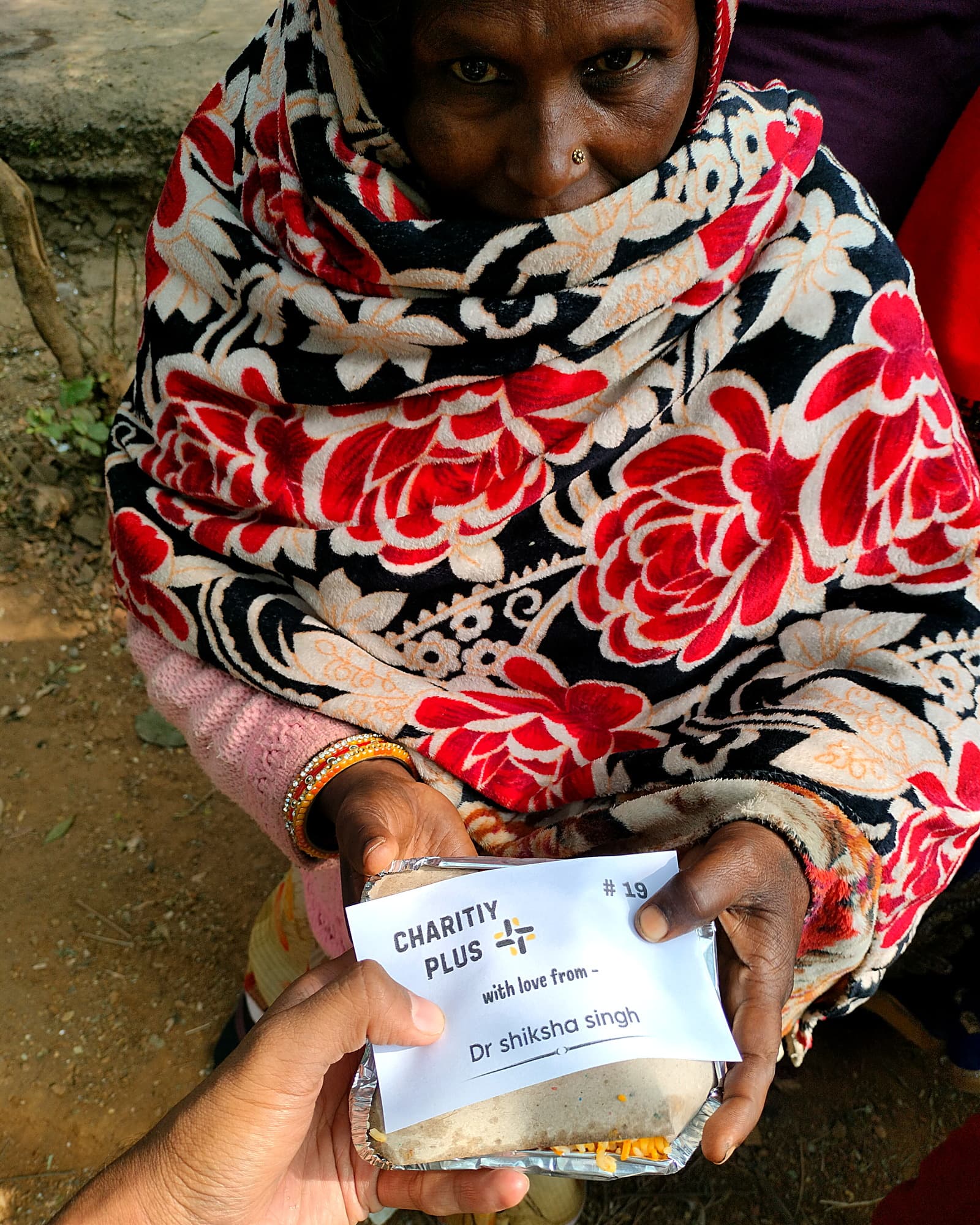 An elderly woman receives a food packet, #19